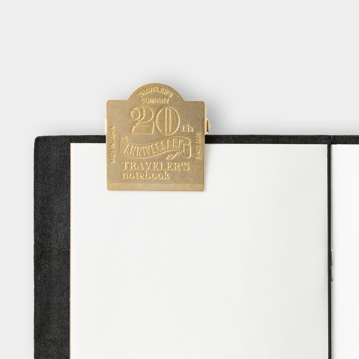 Brass anniversary charm attached to Traveler&