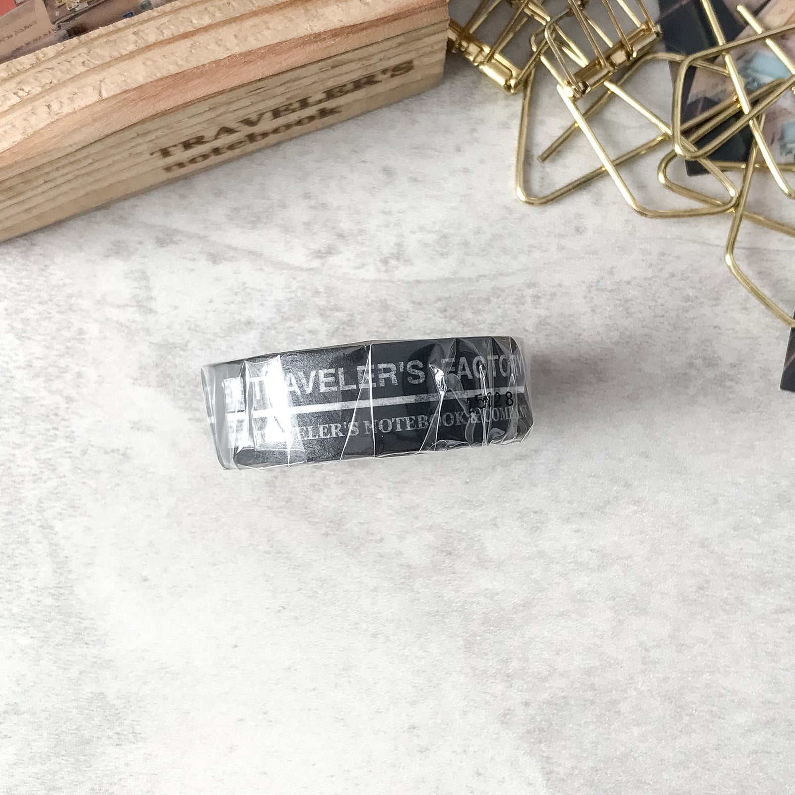 Traveler's Factory TFA Pattern black washi tape next to notebook and pen