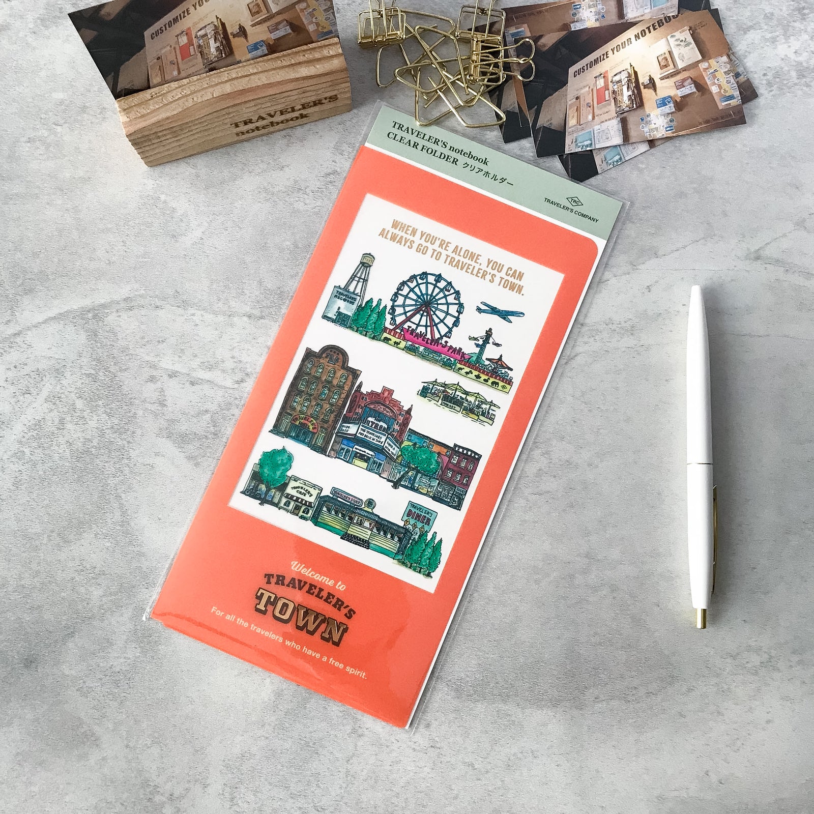 Open view of the limited-edition 2024 TRAVELER’S TOWN clear folder showing storage space for A4 tri-fold papers.