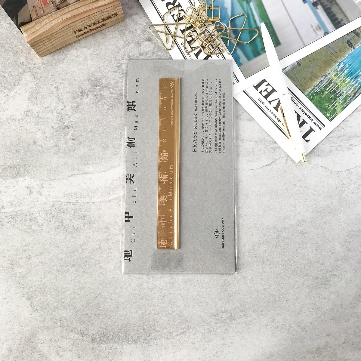 Packaged Chichu Art Museum brass ruler photographed from above