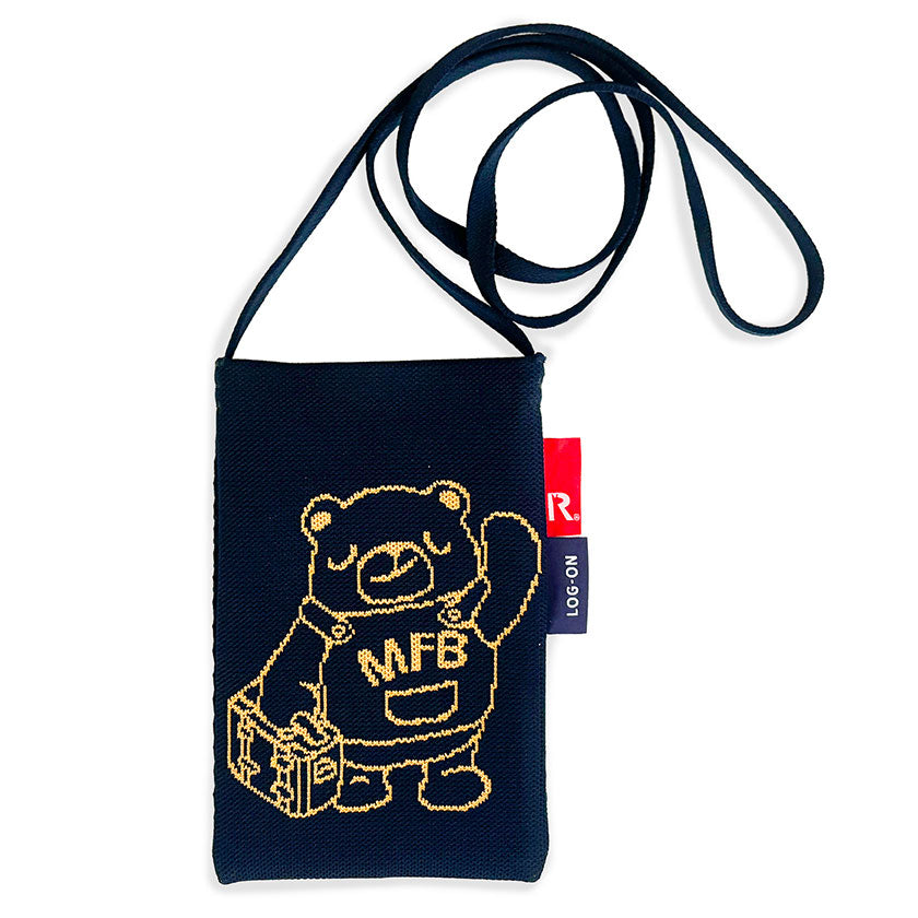 A navy blue fabric crossbody pouch featuring a gold embroidered cartoon bear holding a suitcase with 'MFE' written on its chest, complete with a black strap and a small red brand tag.