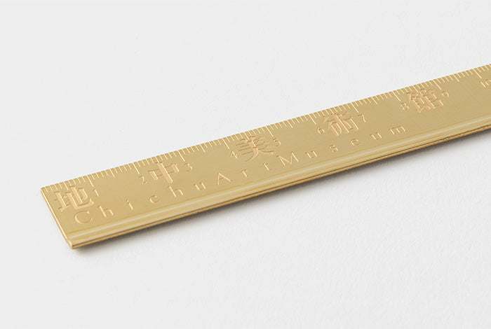 Close-up angled view of the solid brass ruler